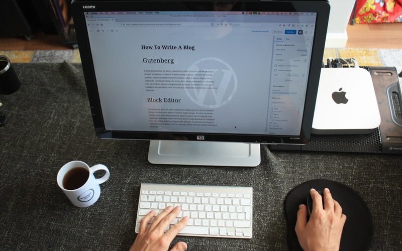 typing in front of a desktop using WordPress