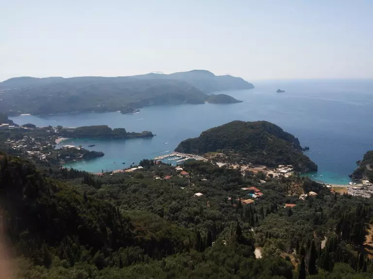 View of Palaiokastritsa, calm sea with two bays foul of trees